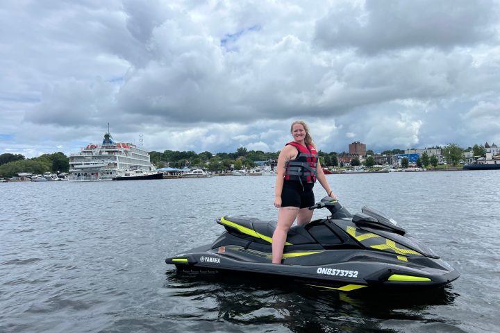 a person riding on the back of a boat in the water